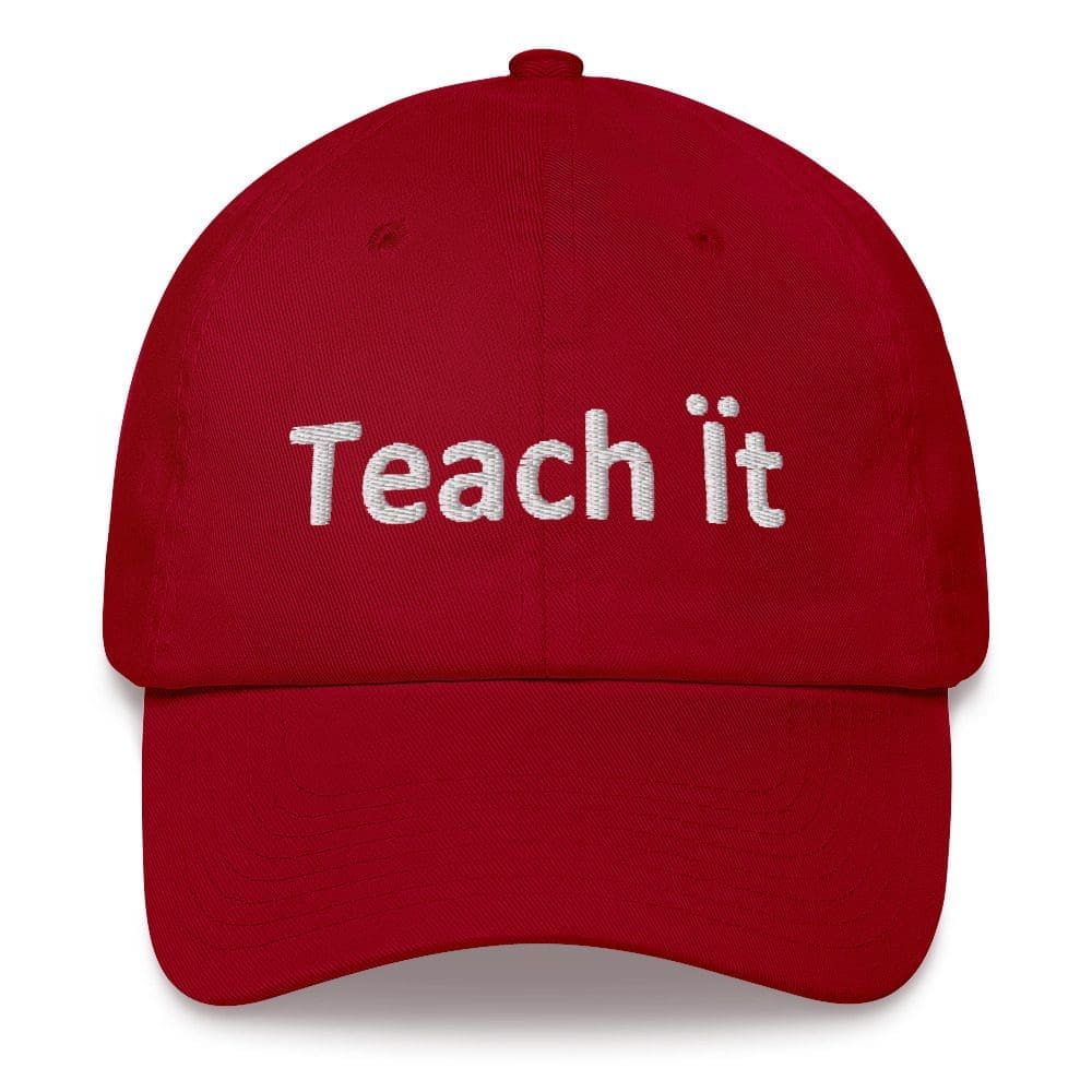 Red cap embroidered with "Teach it"