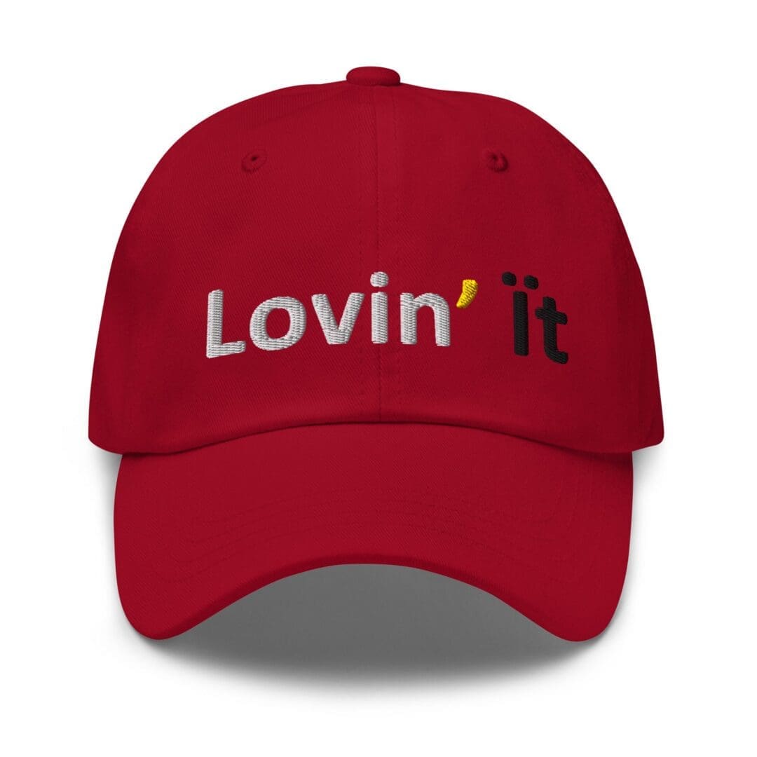Red baseball cap embroidered "Lovin' it"