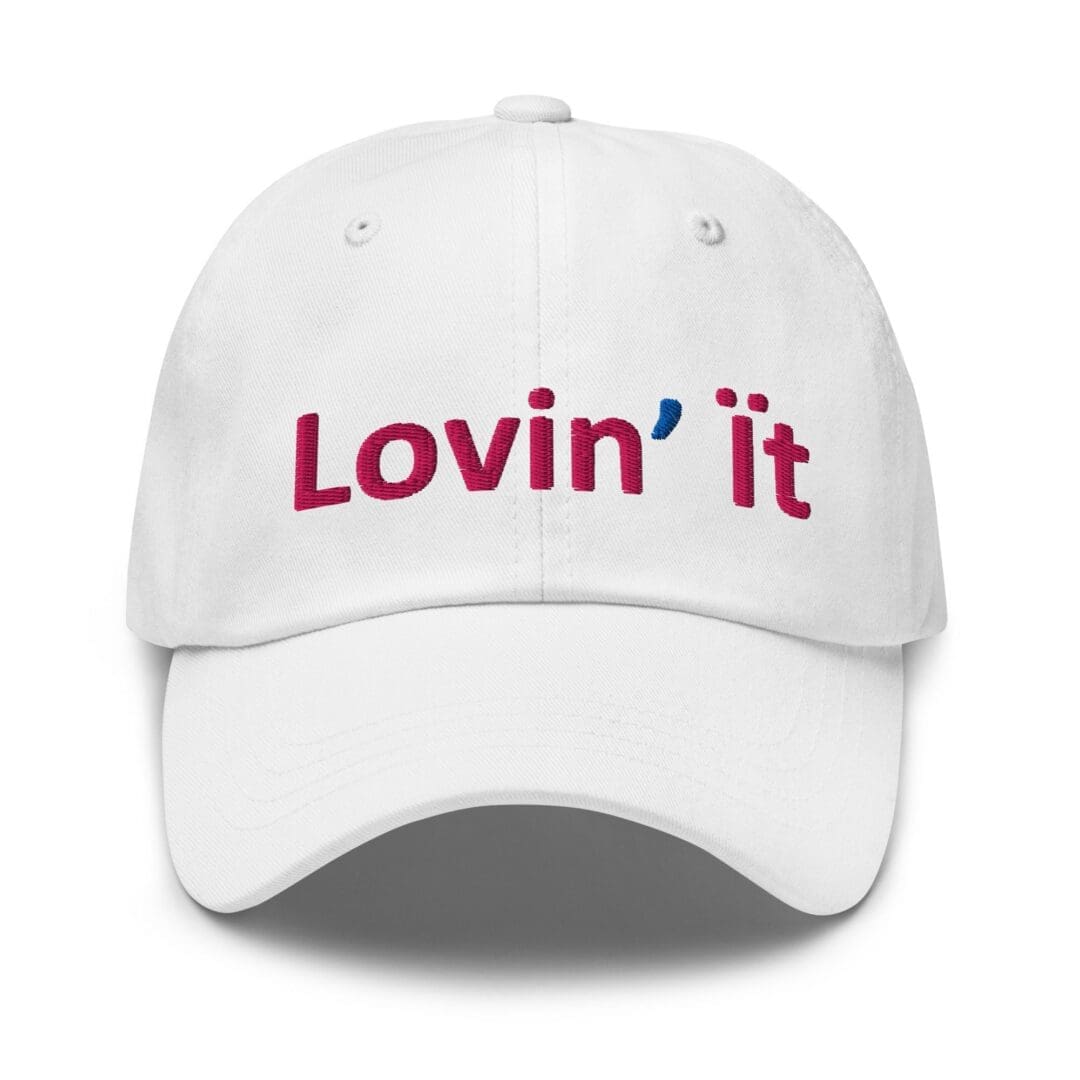 White baseball cap embroidered with "Lovin' it"